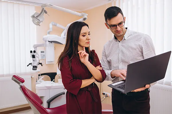 female dentist consulting with a marketing specialist in her clinic