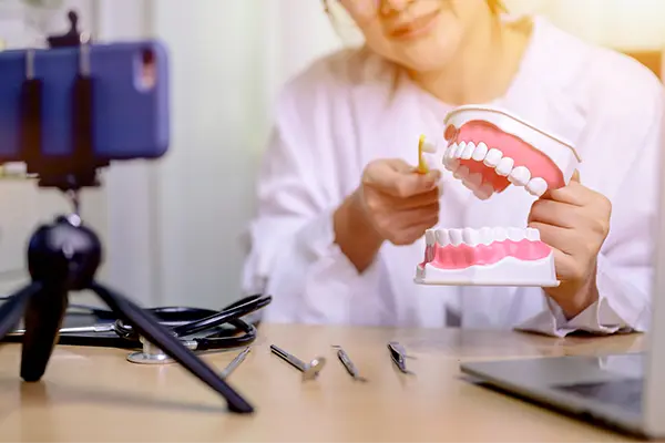 female dentist creating educational content using a mobile phone